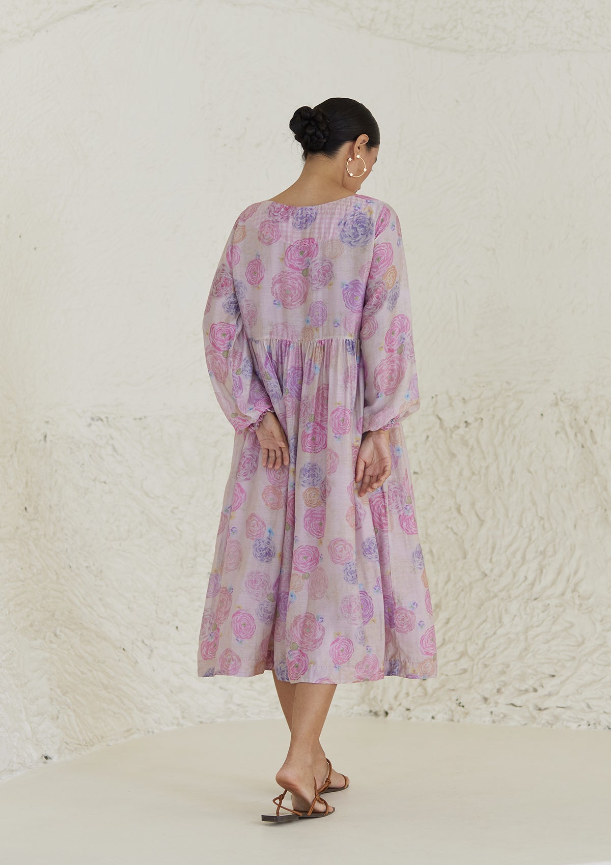 Floral pink dress in handwoven silk modal, from Surmaye. Ranunculus flower print, handmade in watercolour. Round neckline, and a full sleeve ruched at the hem.