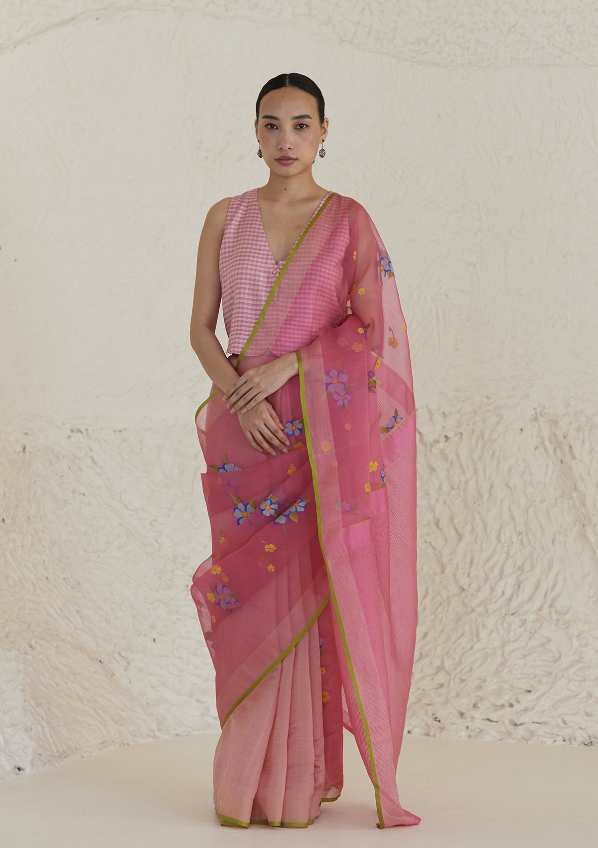 Handloom organza mulberry silk jamdani saree in carnation pink, from Surmaye. Intricate all-over floral motifs. Paired with designer blouse with pink gingham checks.