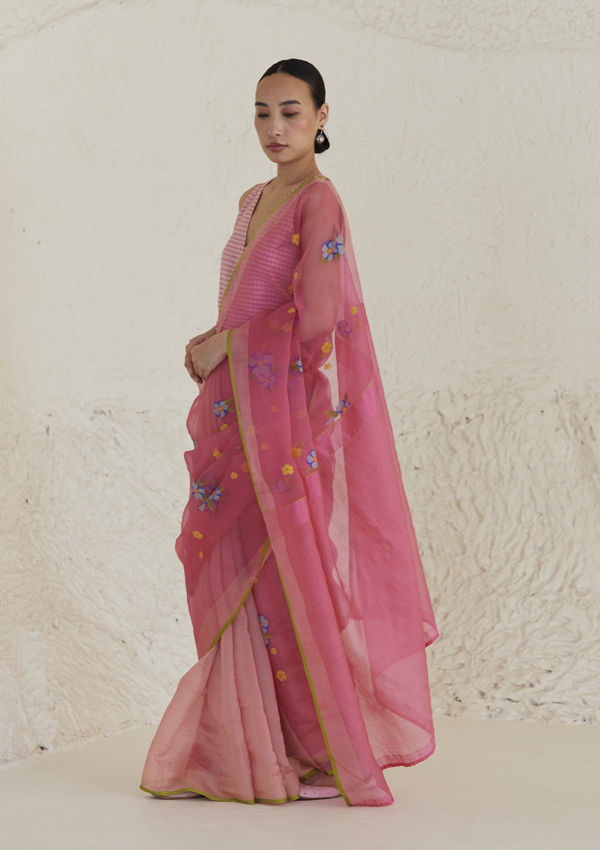 Handloom organza mulberry silk jamdani saree in carnation pink, from Surmaye. Intricate all-over floral motifs. Paired with designer blouse with pink gingham checks.