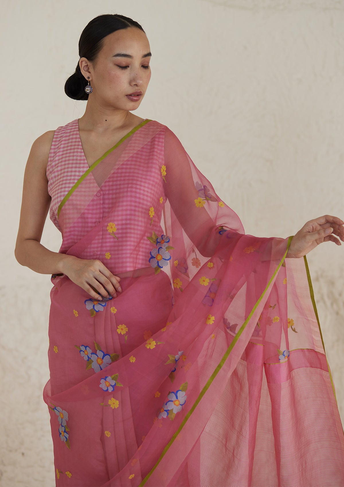 Handloom organza mulberry silk jamdani saree in carnation pink, from Surmaye. Intricate all-over floral motifs. Paired with designer blouse with pink gingham checks.