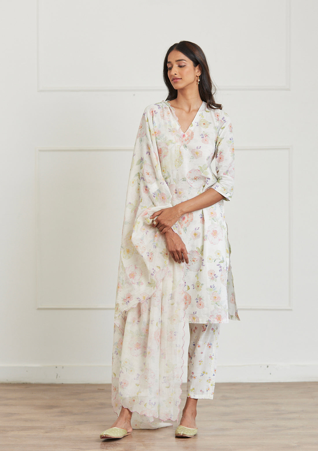 Ivory Kurta Set for women, from Surmaye. Made in handwoven khadi with a hand-drawn floral print, and a decorative running stitch accent.