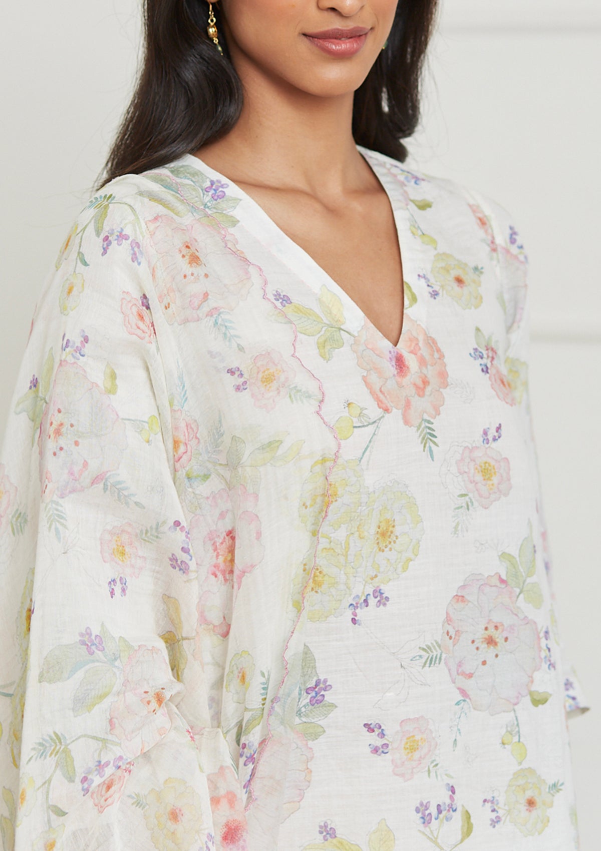 Ivory Kurta Set for women, from Surmaye. Made in handwoven khadi with a hand-drawn floral print, and a decorative running stitch accent.