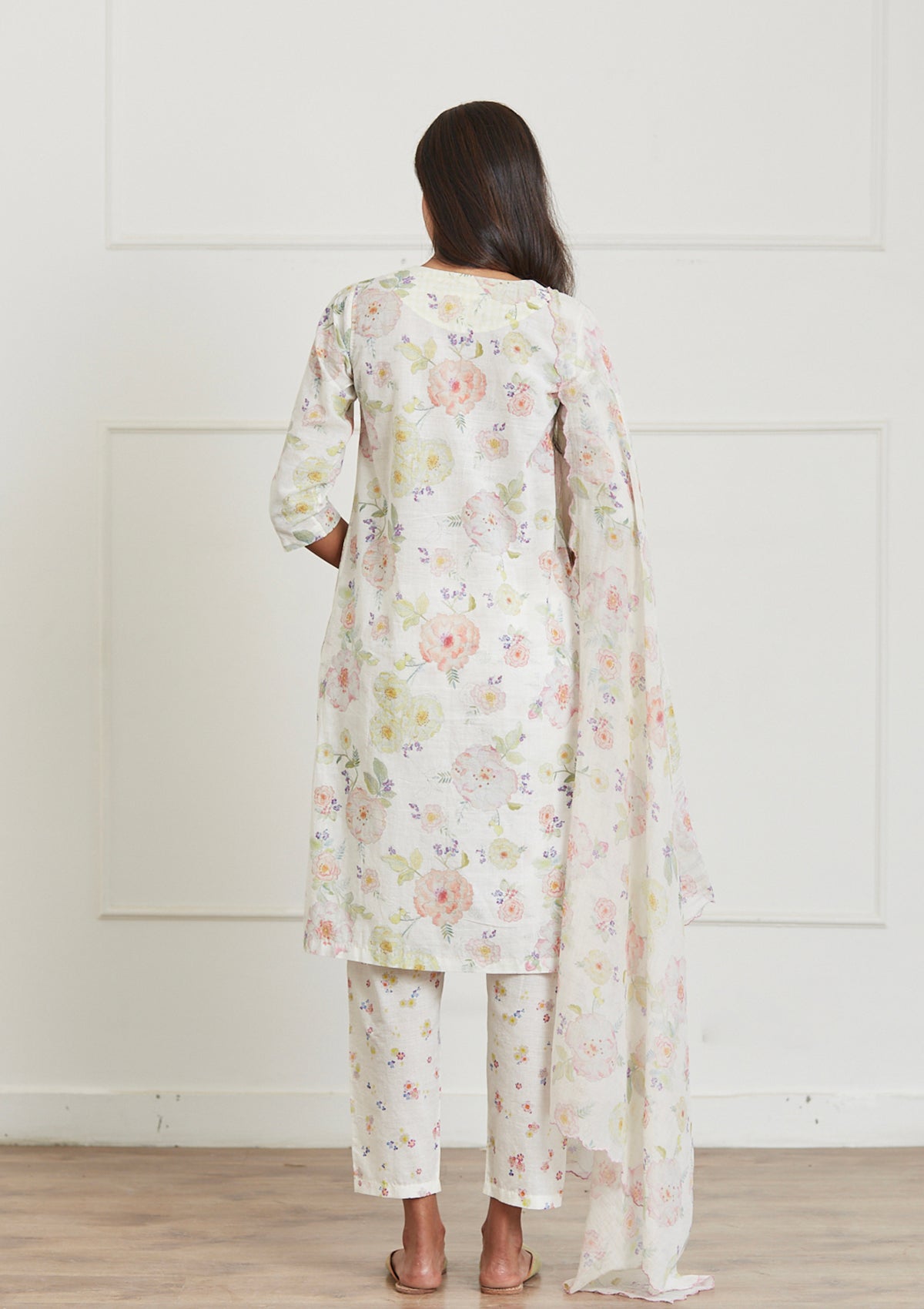 Ivory Kurta Set for women, from Surmaye. Made in handwoven khadi with a hand-drawn floral print, and a decorative running stitch accent.