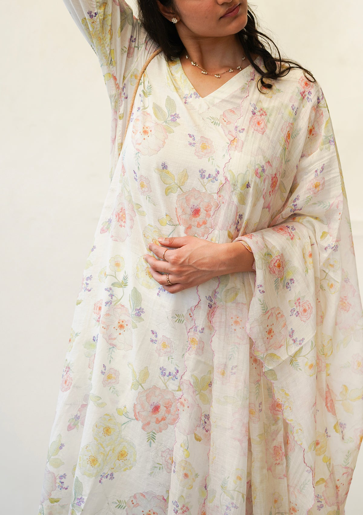 Ivory Kurta Set for women, from Surmaye. Made in handwoven khadi with a hand-drawn floral print, and a decorative running stitch accent.