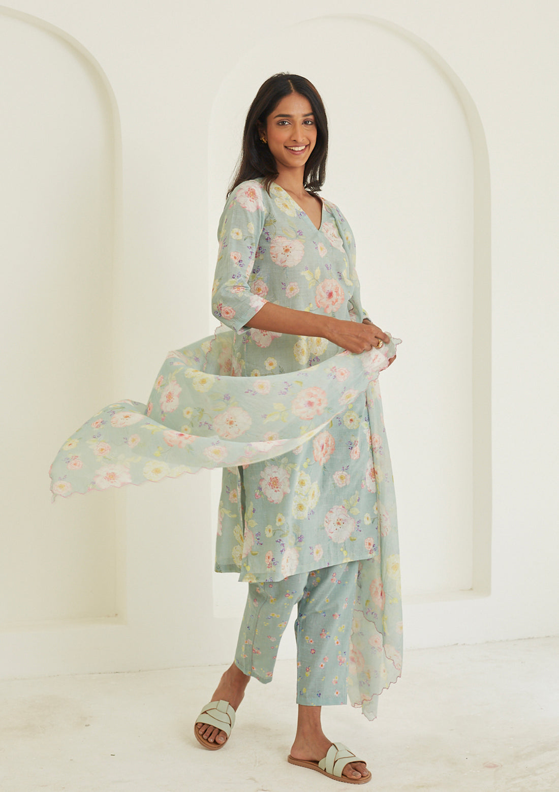 Sage-green Kurta Set for women, from Surmaye. Made in handwoven khadi with a hand-drawn floral print, and a decorative running stitch accent.