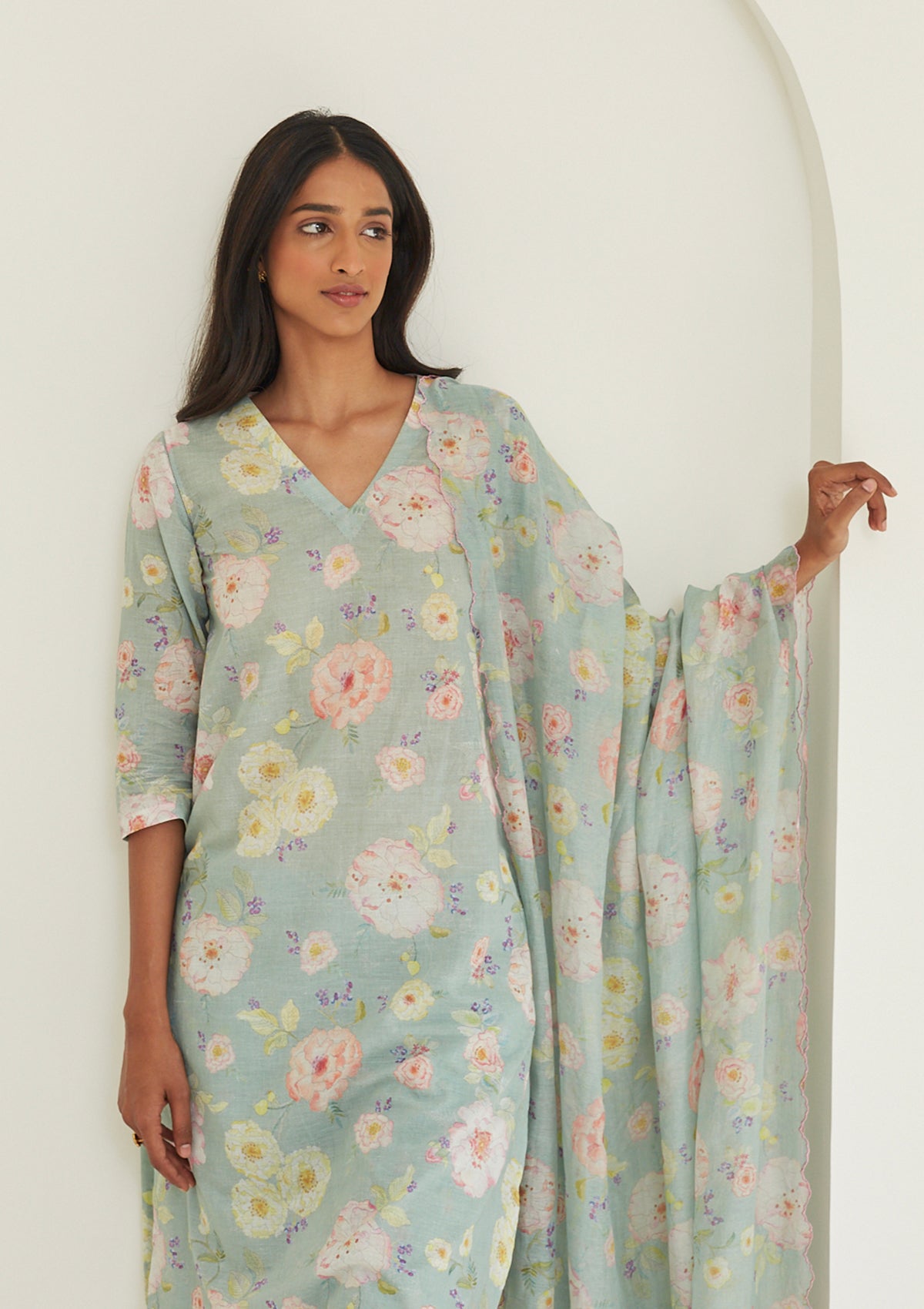 Sage-green Kurta Set for women, from Surmaye. Made in handwoven khadi with a hand-drawn floral print, and a decorative running stitch accent.