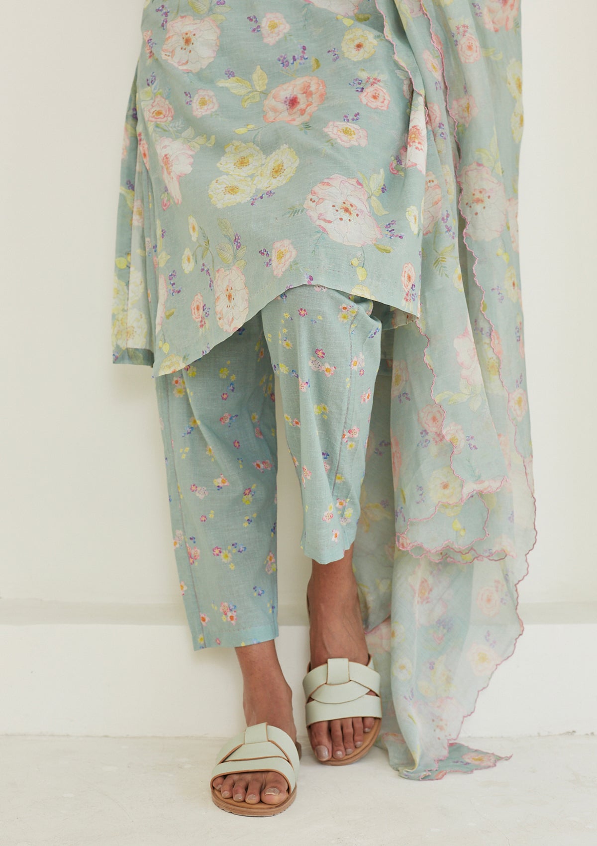 Sage-green Kurta Set for women, from Surmaye. Made in handwoven khadi with a hand-drawn floral print, and a decorative running stitch accent.