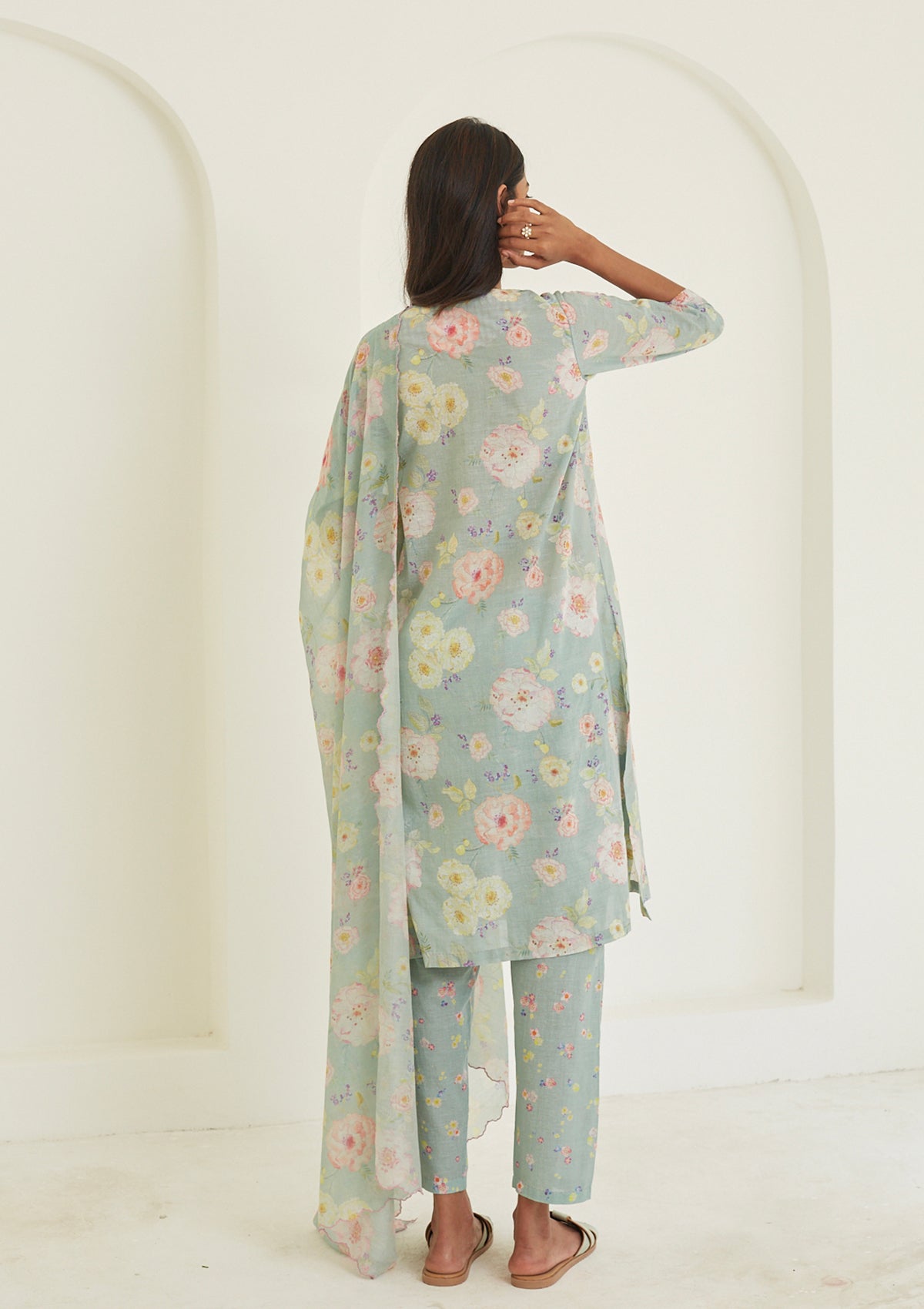 Sage-green Kurta Set for women, from Surmaye. Made in handwoven khadi with a hand-drawn floral print, and a decorative running stitch accent.
