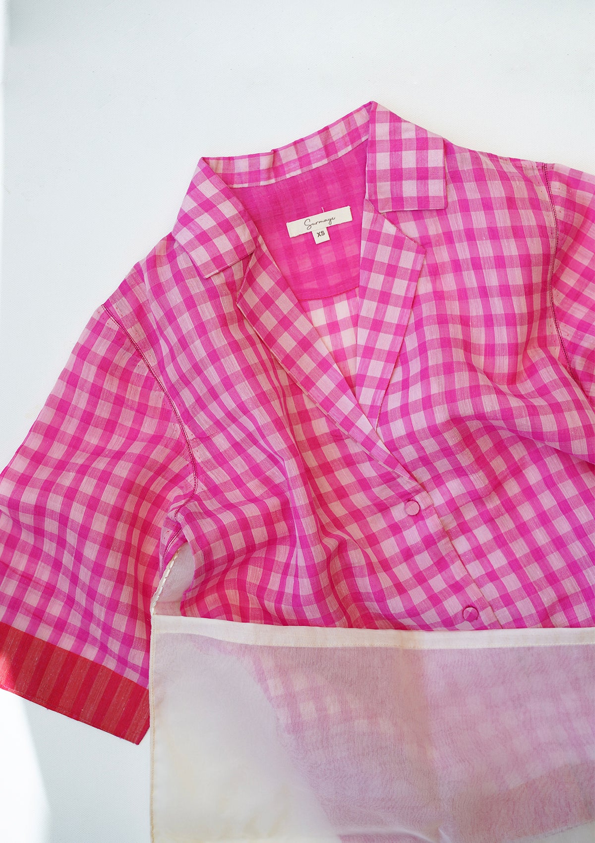 Pink designer blouse in softest handwoven silk khadi, from Surmaye. Gingham checks pattern in a shirt silhouette.