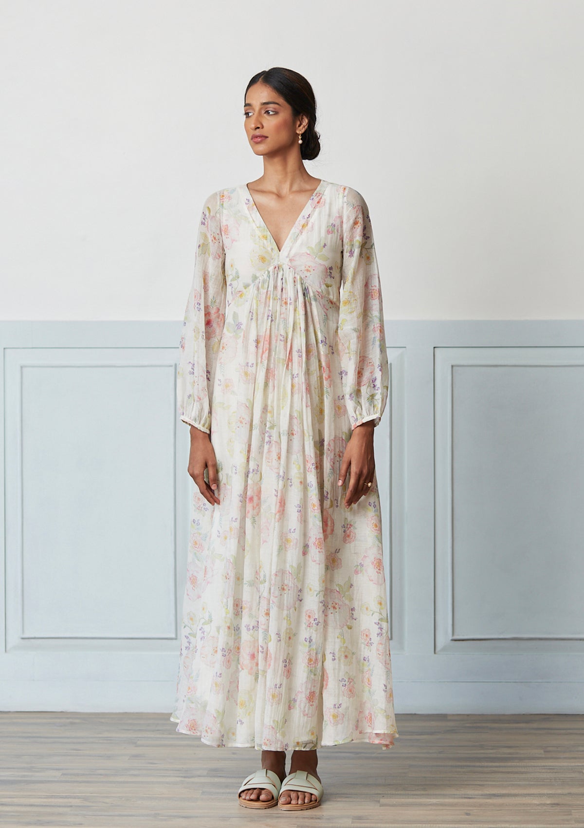 Handwoven maxi dress in sooti chanderi, from Surmaye. Ivory dress with hand-painted floral print, and a v-neck.