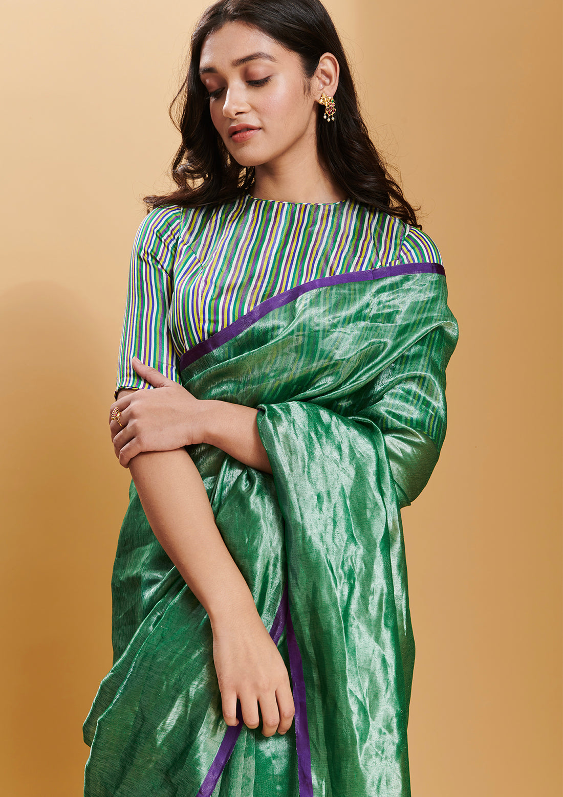 Green handloom saree from Surmaye, made with handwoven mulberry silk zari. Contrasting purple satin border.