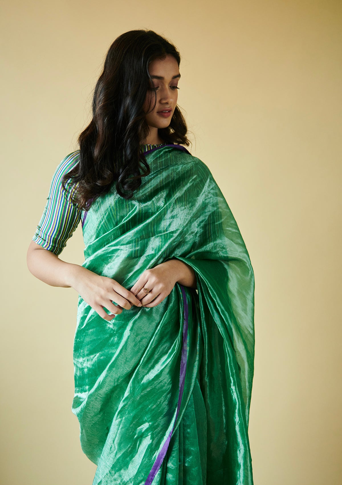 Green handloom saree from Surmaye, made with handwoven mulberry silk zari. Contrasting purple satin border.