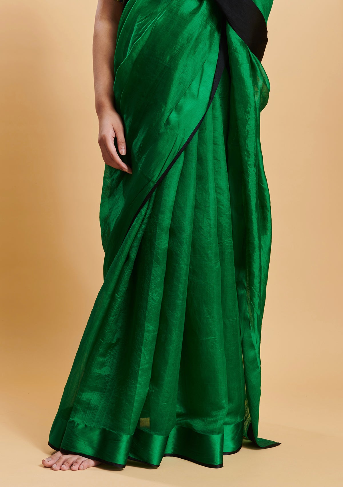 Green handloom saree in handwoven organza mulberry silk, from Surmaye. Dual-colour reversible border in green and black.
