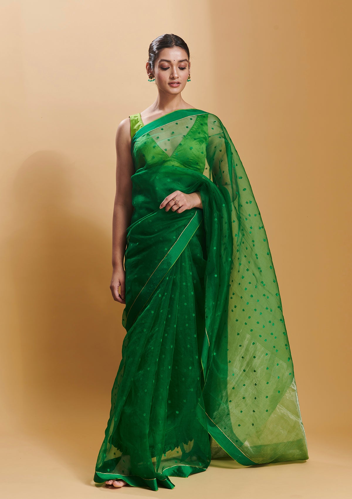 Green handloom silk organza jamdani saree, from Surmaye. Adorned with all-over jamdani weave dots.