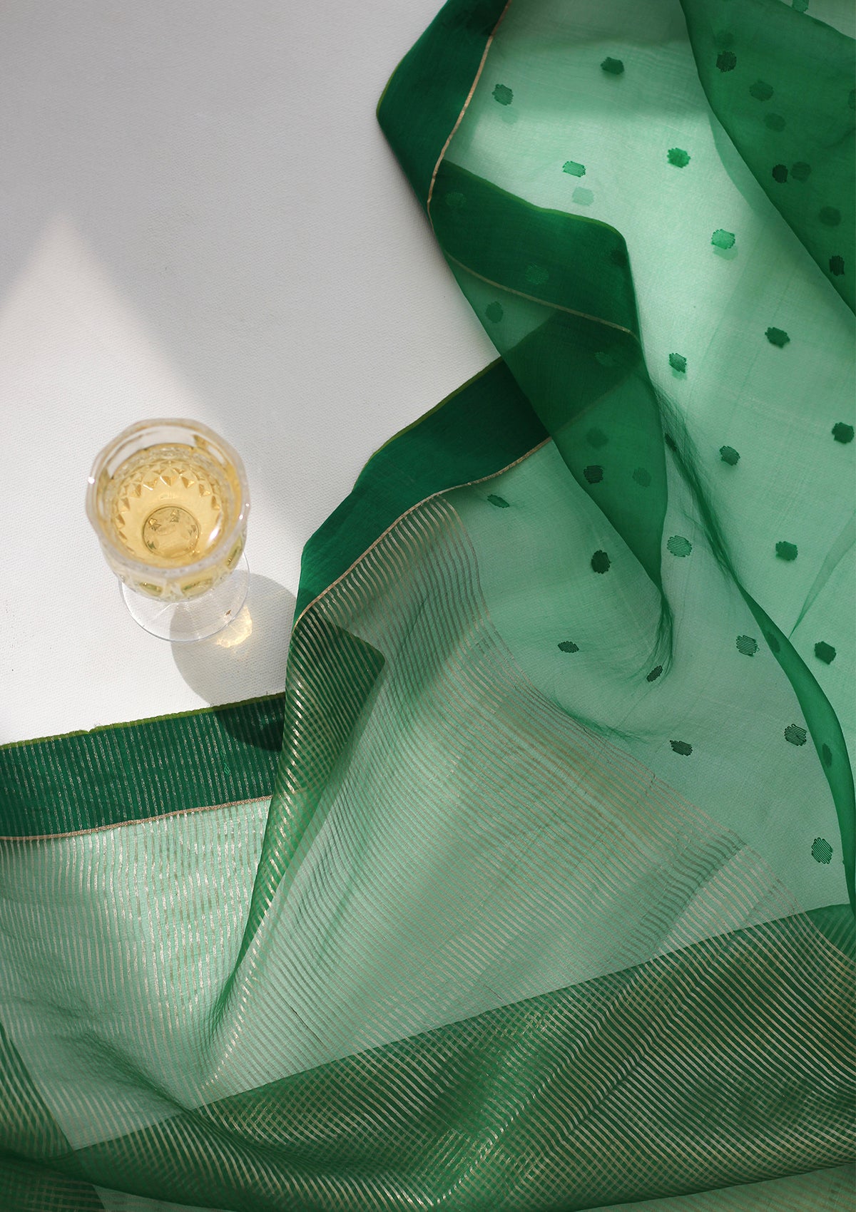 Green handloom silk organza jamdani saree, from Surmaye. Adorned with all-over jamdani weave dots.