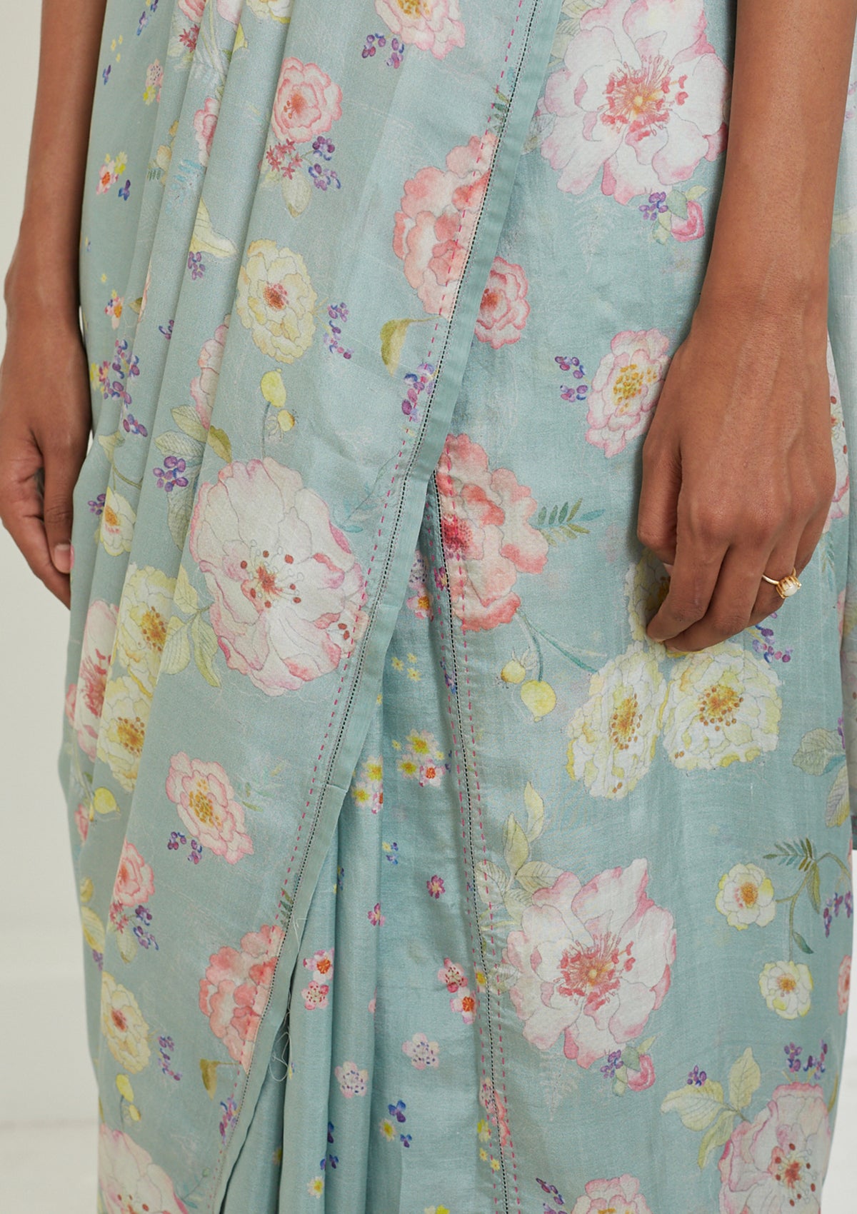 Handloom sage green saree from Surmaye. Hand-painted floral print on handwoven mulberry silk. Contrast stitching detail.