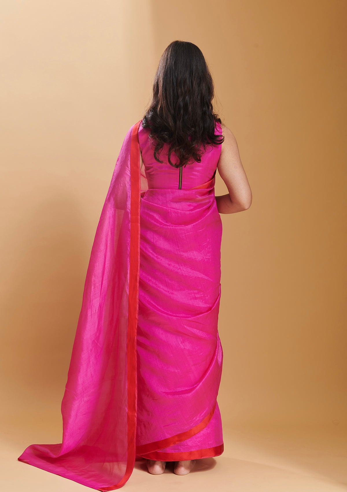 Pink handloom saree in handwoven organza mulberry silk, from Surmaye. Dual-colour reversible border in pink and red.