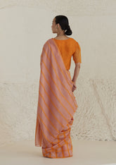 Handloom silk modal saree from Surmaye, having a check pattern with shades of pink and orange. Paired with orange designer blouse, with scalloped embroidery edges all over.