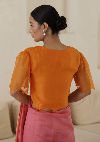 Orange designer blouse, crafted in handwoven organza silk, from Surmaye. Scalloped embroidery edges all over. Lined with handwoven mulberry silk.