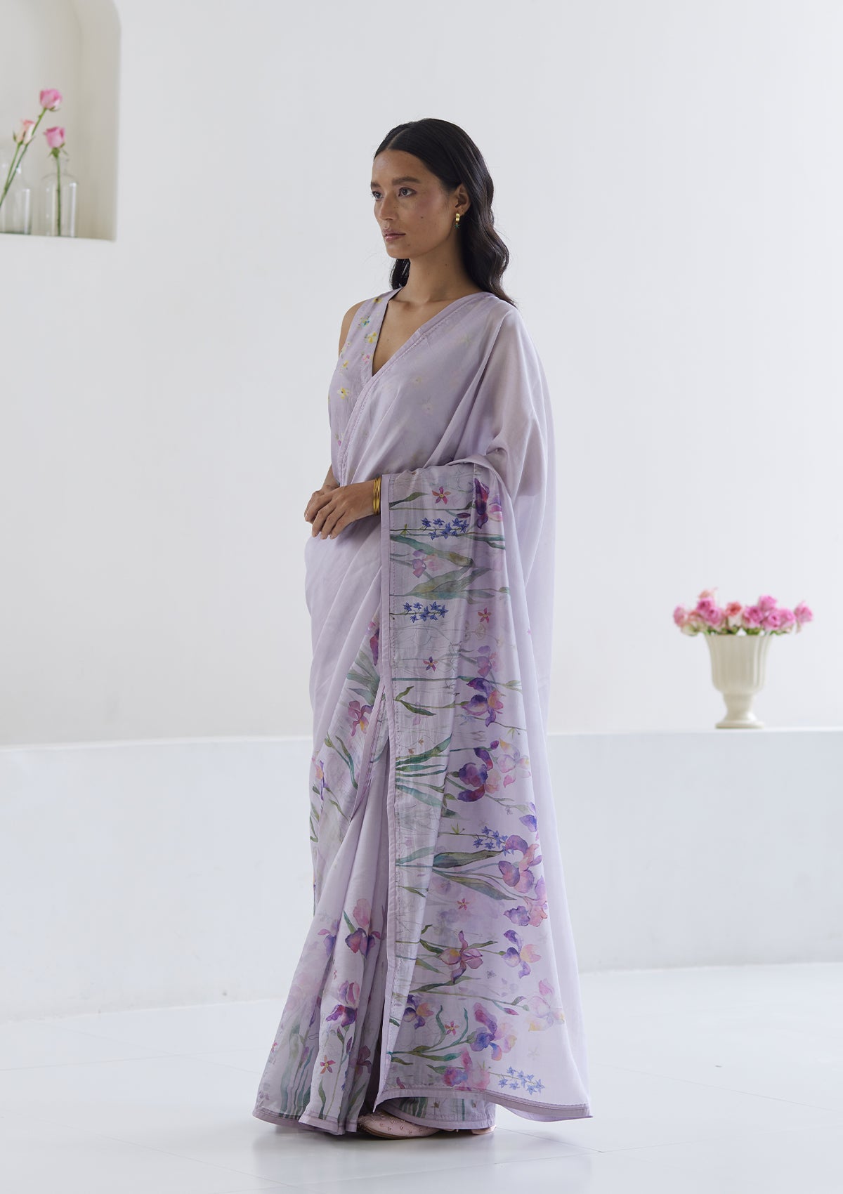 Handloom organza mulberry silk saree in mauve, from Surmaye. Intricate, hand-drawn, iris flower border print. Paired with mauve designer blouse in floral print.