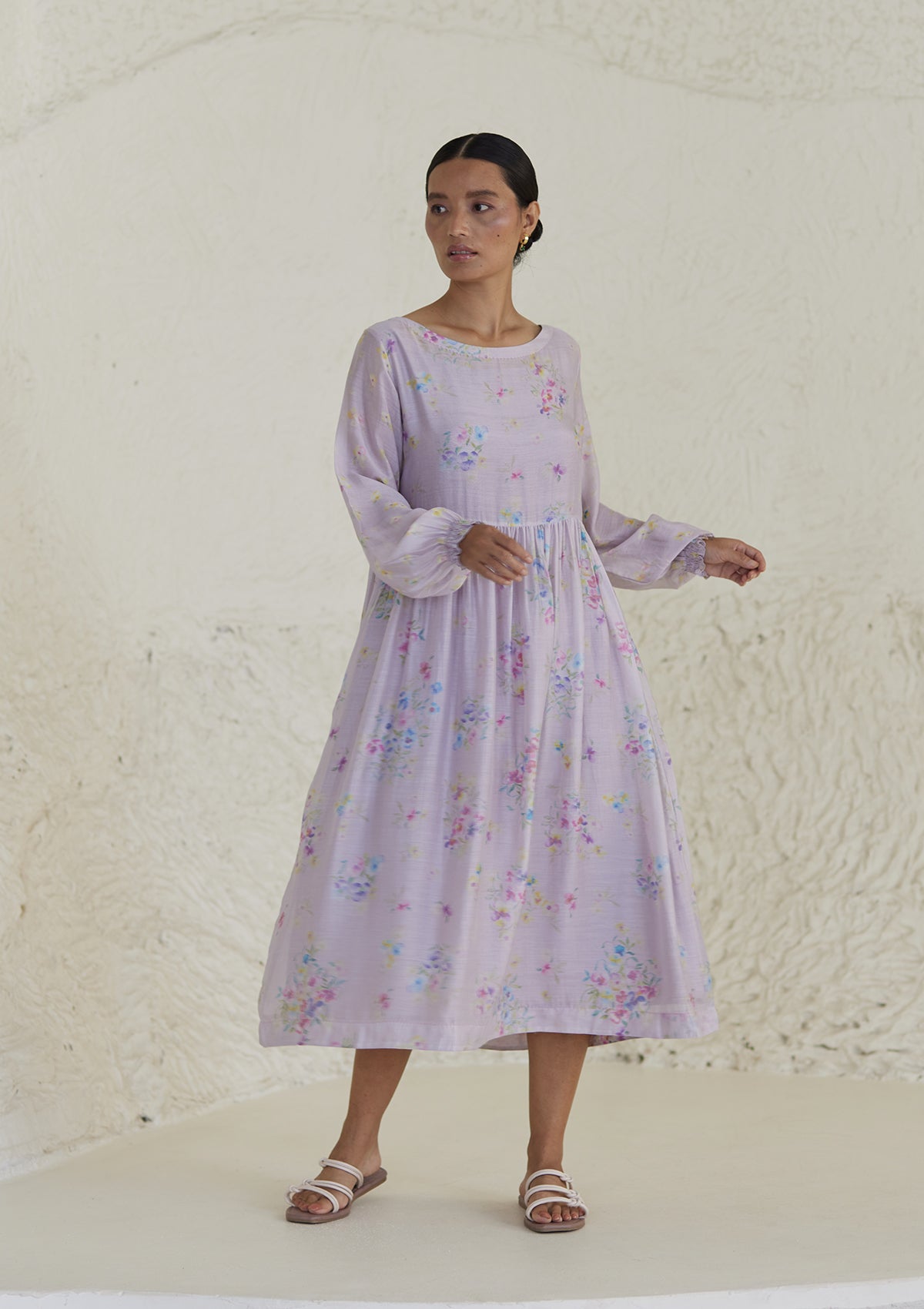 Floral mauve dress in silk modal, from Surmaye. All-over pansy print, handmade in watercolour. Round neckline, and a full sleeve ruched at the hem.