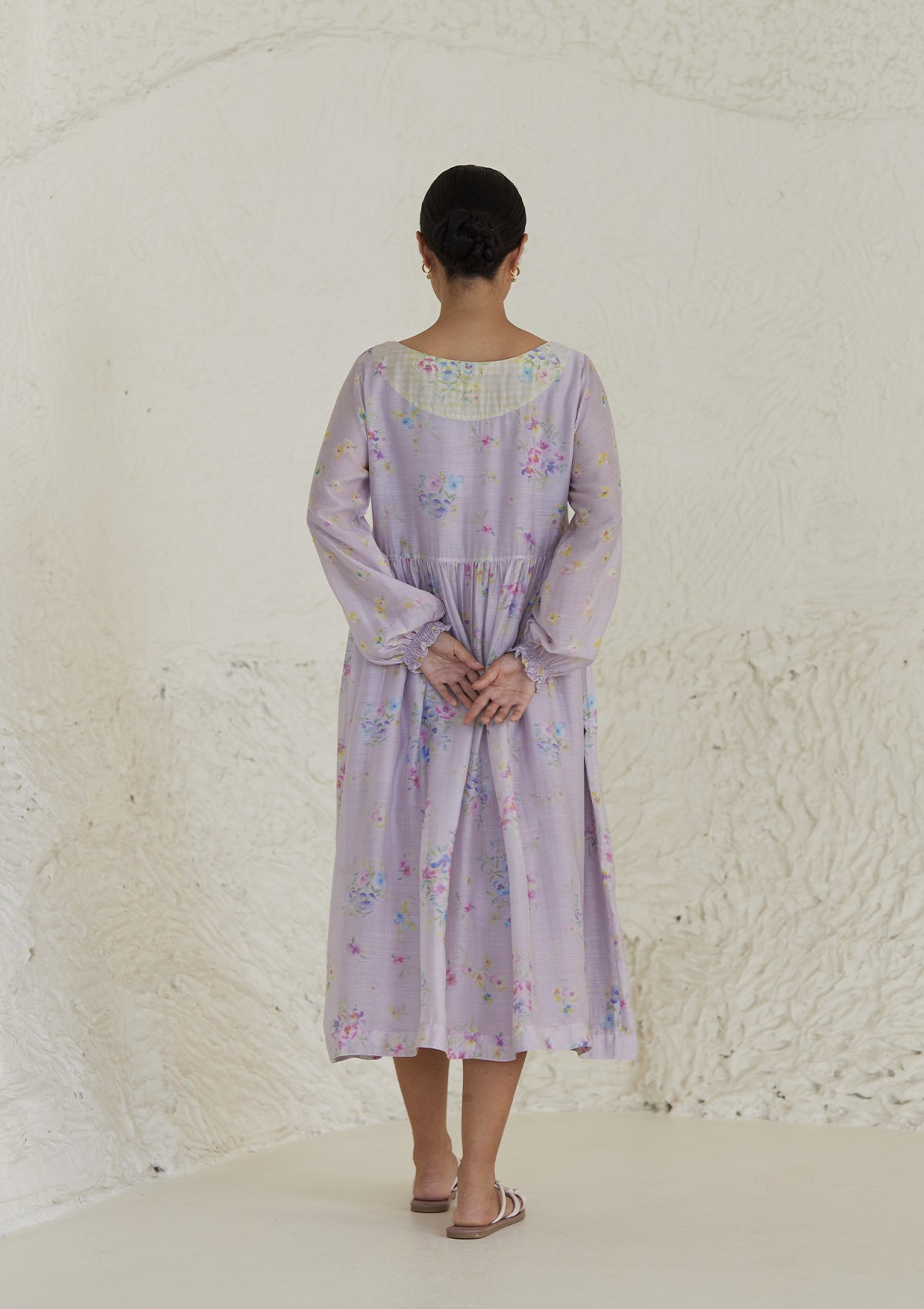 Floral mauve dress in silk modal, from Surmaye. All-over pansy print, handmade in watercolour. Round neckline, and a full sleeve ruched at the hem.