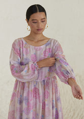 Floral pink dress in handwoven silk modal, from Surmaye. Ranunculus flower print, handmade in watercolour. Round neckline, and a full sleeve ruched at the hem.