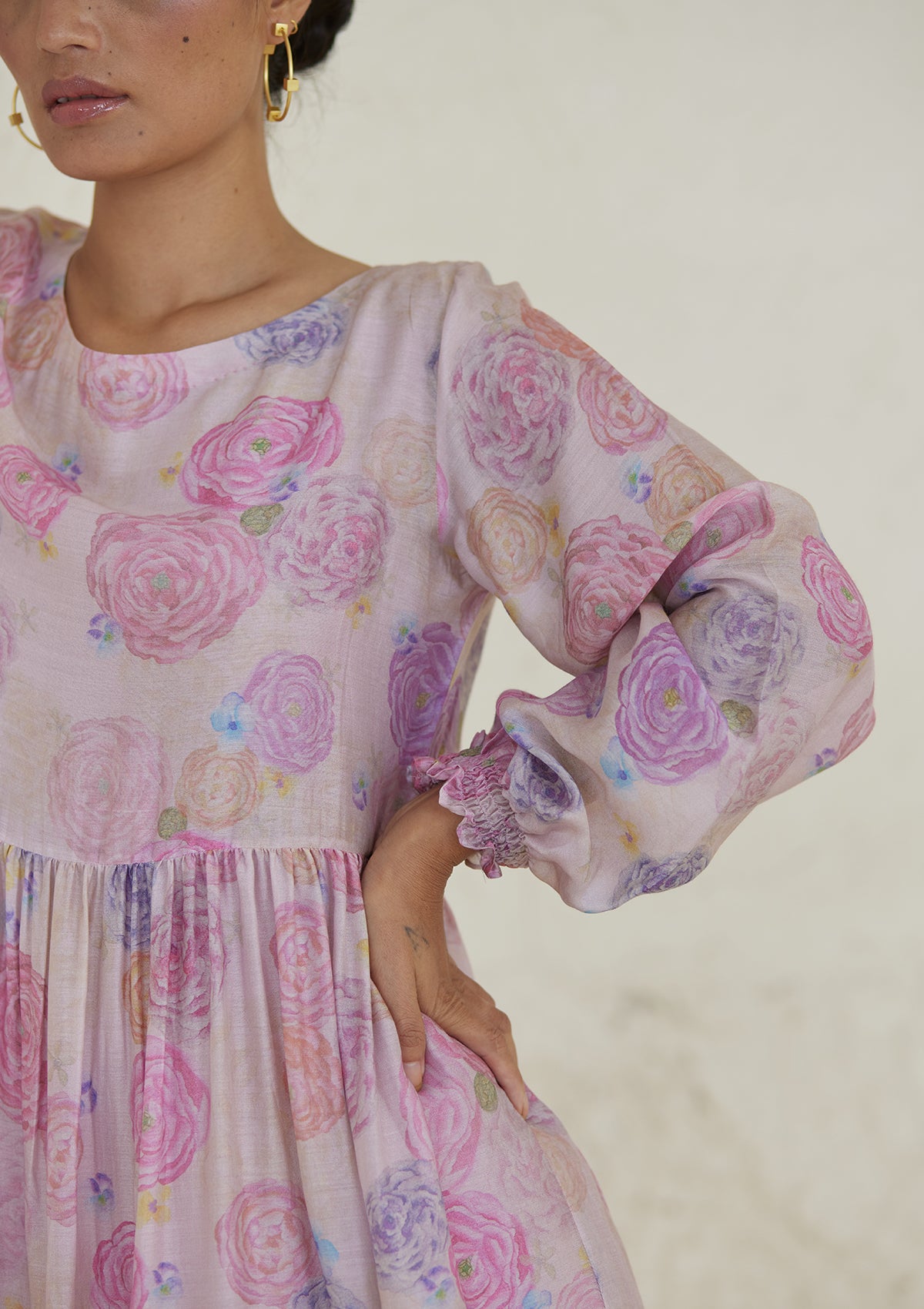 Floral pink dress in handwoven silk modal, from Surmaye. Ranunculus flower print, handmade in watercolour. Round neckline, and a full sleeve ruched at the hem.