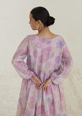 Floral pink dress in handwoven silk modal, from Surmaye. Ranunculus flower print, handmade in watercolour. Round neckline, and a full sleeve ruched at the hem.