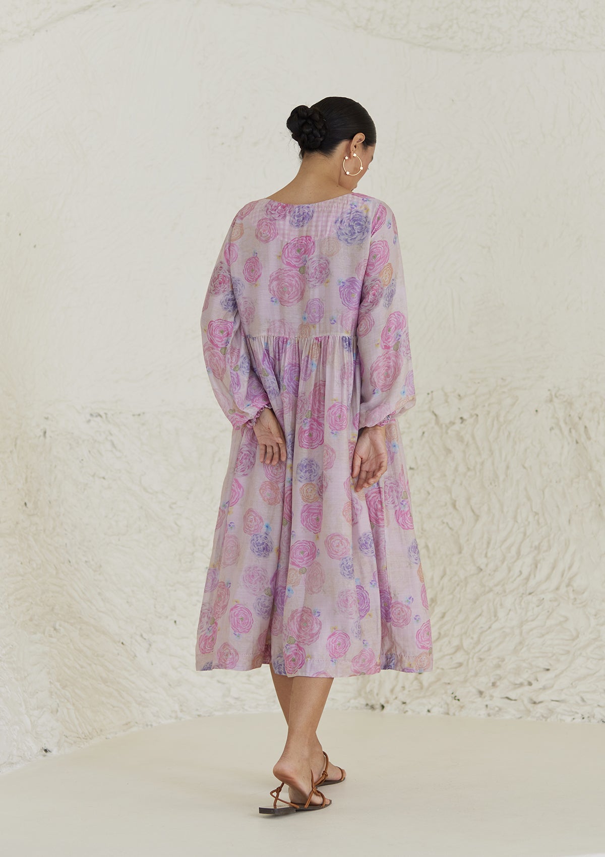 Floral pink dress in handwoven silk modal, from Surmaye. Ranunculus flower print, handmade in watercolour. Round neckline, and a full sleeve ruched at the hem.