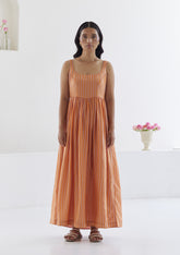 Handwoven maxi dress in silk modal, from Surmaye. Sleeveless dress in a fit-and-flare silhouette, with pink and orange stripes.  Full view.