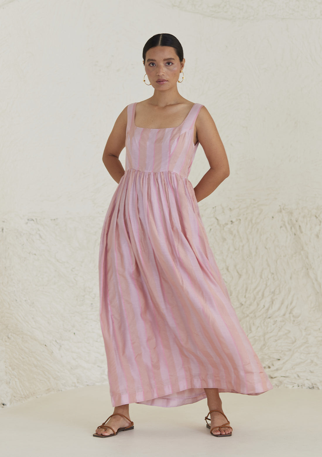 Handwoven maxi pink dress in silk modal, from Surmaye. Sleeveless dress in a fit-and-flare silhouette, with dual-toned pink stripes.