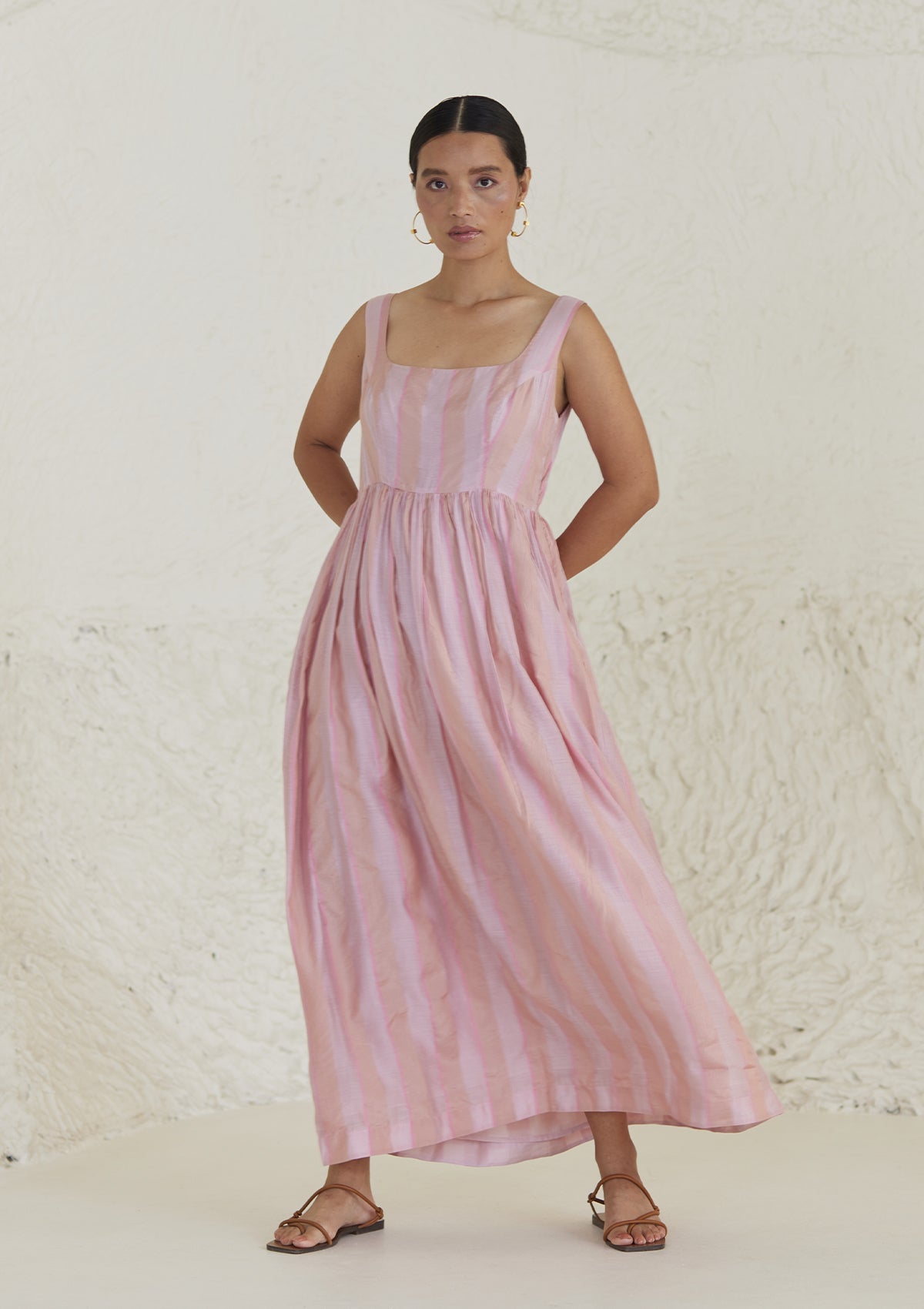 Handwoven maxi pink dress in silk modal, from Surmaye. Sleeveless dress in a fit-and-flare silhouette, with dual-toned pink stripes. 