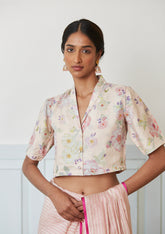 Designer blouse from Surmaye in champagne colour, made with handwoven mulberry silk. Hand-drawn floral print and a collared shirt silhouette.