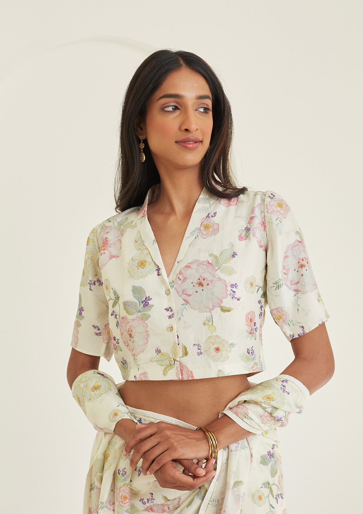 Designer ivory blouse from Surmaye, made with handwoven mulberry silk. Hand-drawn floral print and a collared shirt silhouette.