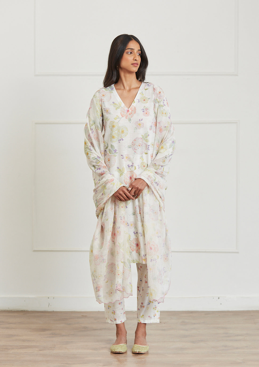 Ivory Kurta Set for women, from Surmaye. Made in handwoven khadi with a hand-drawn floral print, and a decorative running stitch accent.