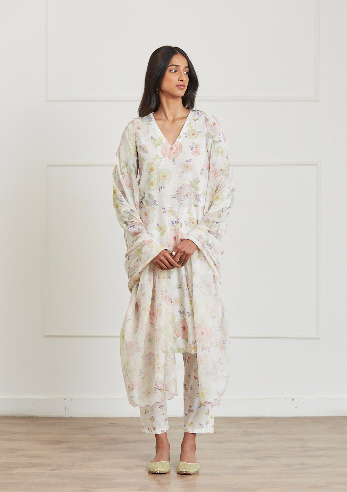 Ivory Kurta Set for women, from Surmaye. Made in handwoven khadi with a hand-drawn floral print, and a decorative running stitch accent. 