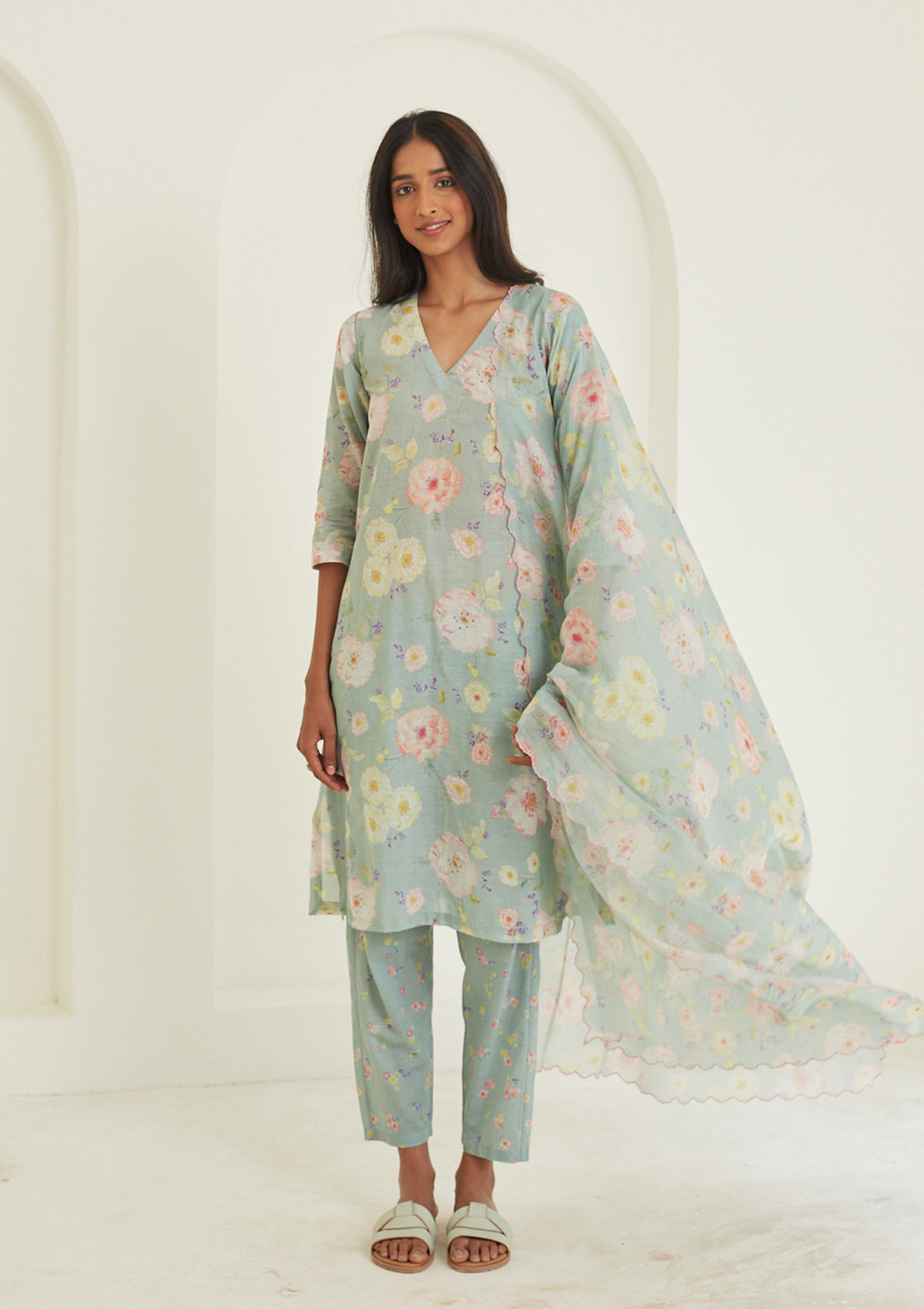 Sage-green Kurta Set for women, from Surmaye. Made in handwoven khadi with a hand-drawn floral print, and a decorative running stitch accent.