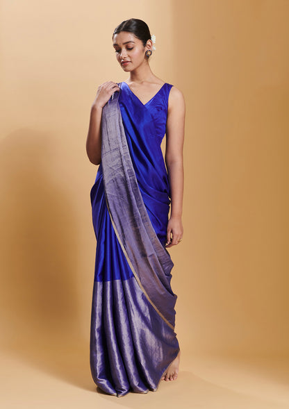 Blue handloom saree from Surmaye, made with mulberry silk satin. Broad zari border at the bottom of the saree. Ideal for festivities. 