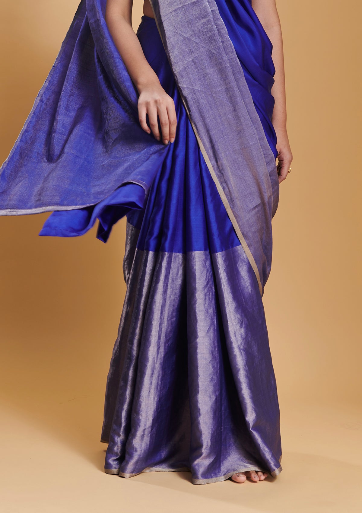 Blue handloom saree from Surmaye, made with mulberry silk satin. Broad zari border at the bottom of the saree. Ideal for festivities. 