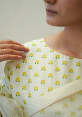 Designer ivory blouse, in a t-shirt silhouette from Surmaye. Close-up of yellow rose print on a soft mulberry silk base.