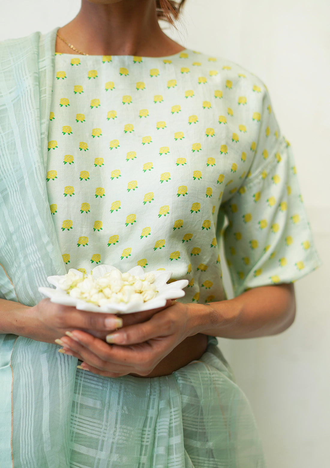 Designer blouse, in seafoam colour and a t-shirt silhouette, from Surmaye. Yellow rose print on a soft mulberry silk base.