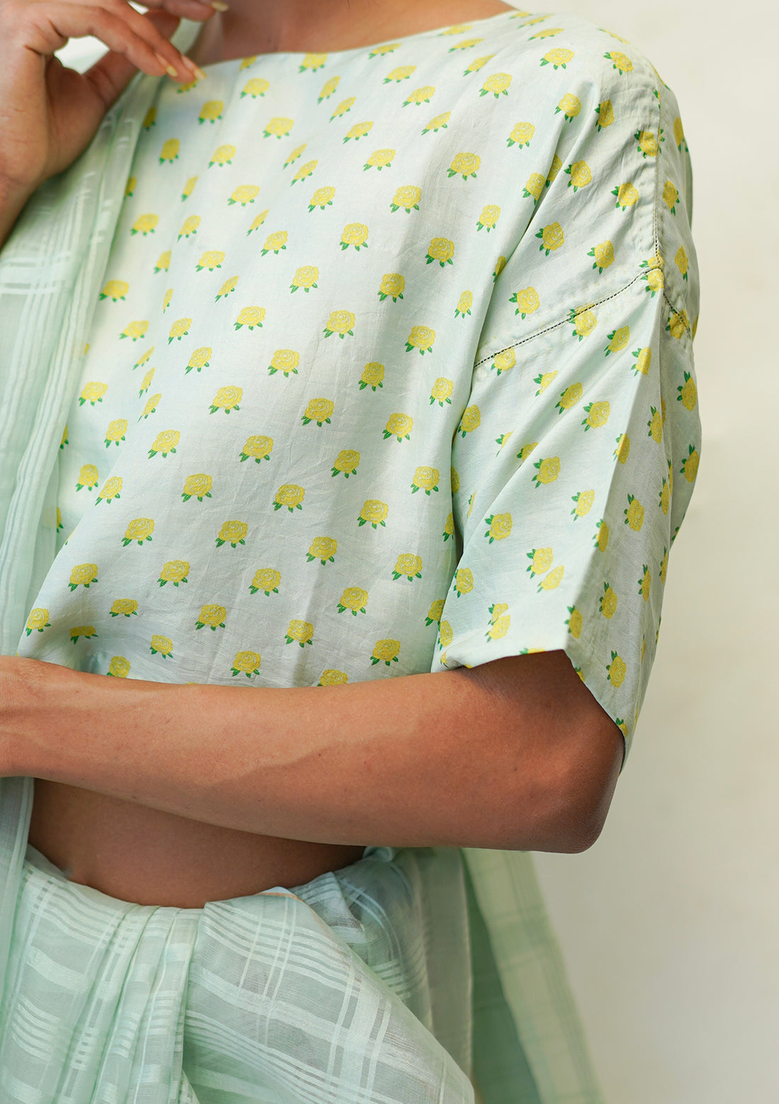 Designer blouse, in seafoam colour and a t-shirt silhouette, from Surmaye. Yellow rose print on a soft mulberry silk base.