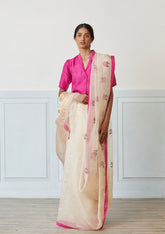 Handloom silk organza jamdani saree, from Surmaye. Intricate rose motifs, woven with silk yarns, on champagne hue of the saree. Paired with a pink designer collar-shirt style blouse.