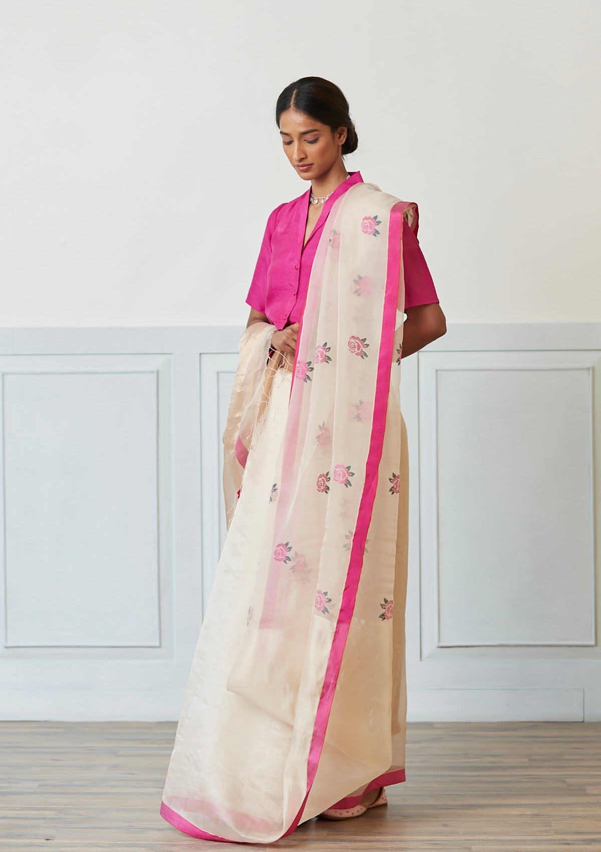 Handloom silk organza jamdani saree, from Surmaye. Intricate rose motifs, woven with silk yarns, on champagne hue of the saree. 