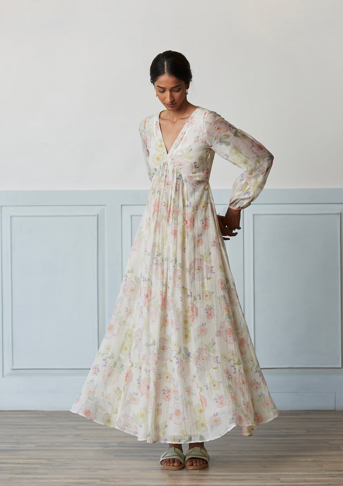 Handwoven maxi dress in sooti chanderi, from Surmaye. Ivory dress with hand-painted floral print, and a v-neck.