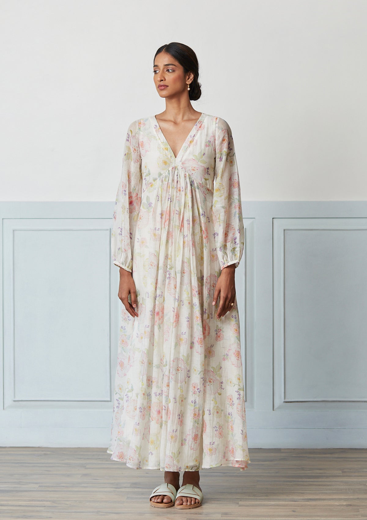 Handwoven maxi dress in sooti chanderi, from Surmaye. Ivory dress with hand-painted floral print, and a v-neck. 