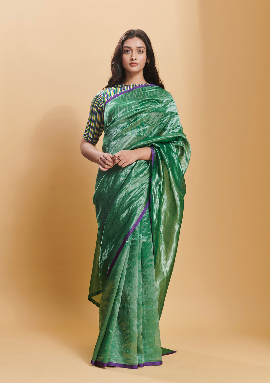 Green handloom saree from Surmaye, made with handwoven mulberry silk zari. Contrasting purple satin border.