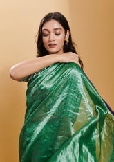 Green handloom saree from Surmaye, made with handwoven mulberry silk zari. Contrasting purple satin border. 