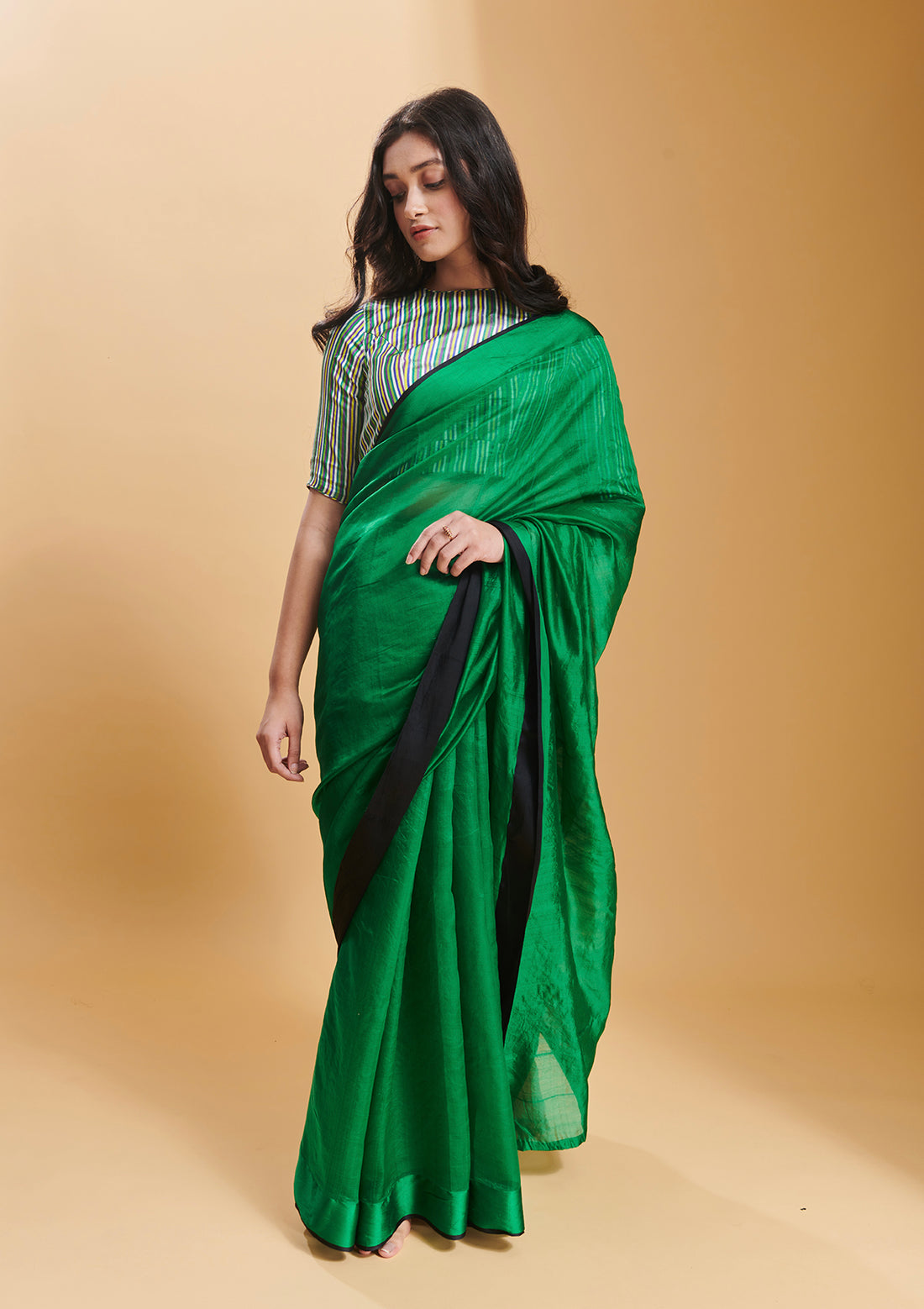 Green handloom saree in handwoven organza mulberry silk, from Surmaye. Dual-colour reversible border in green and black. 